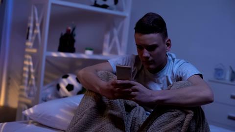 Anxious teenage boy with phone